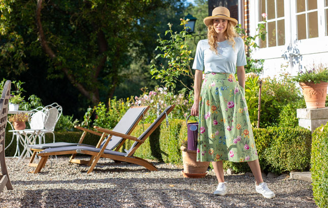 Frau im Garten mit Gießkanne