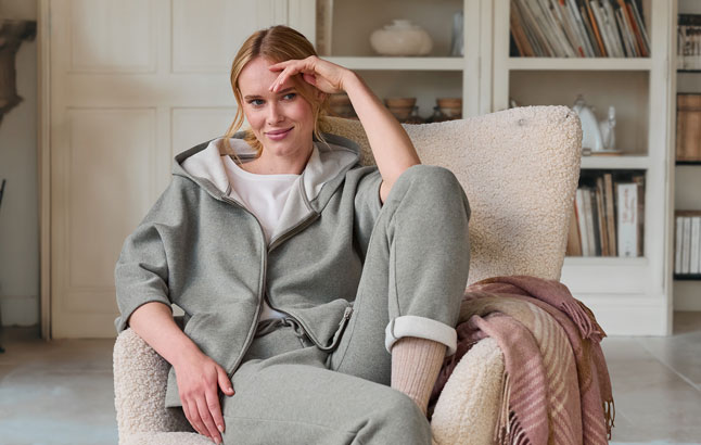Frau im Jogginganzug im Sessel
